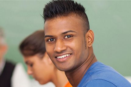 Male smiling student in classroom